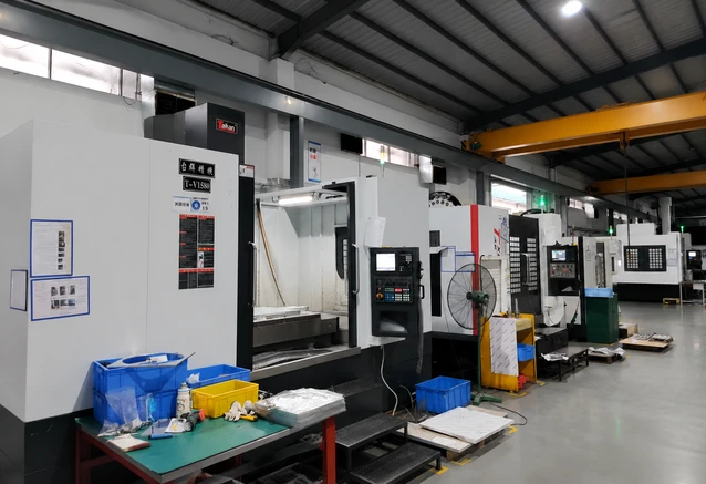 CNC milling machine performing precision metal machining with coolant spray during custom CNC manufacturing