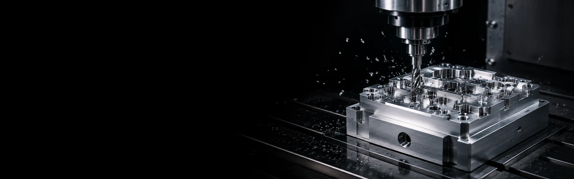 CNC milling machine cutting a complex precision metal part in a dark industrial machining environment