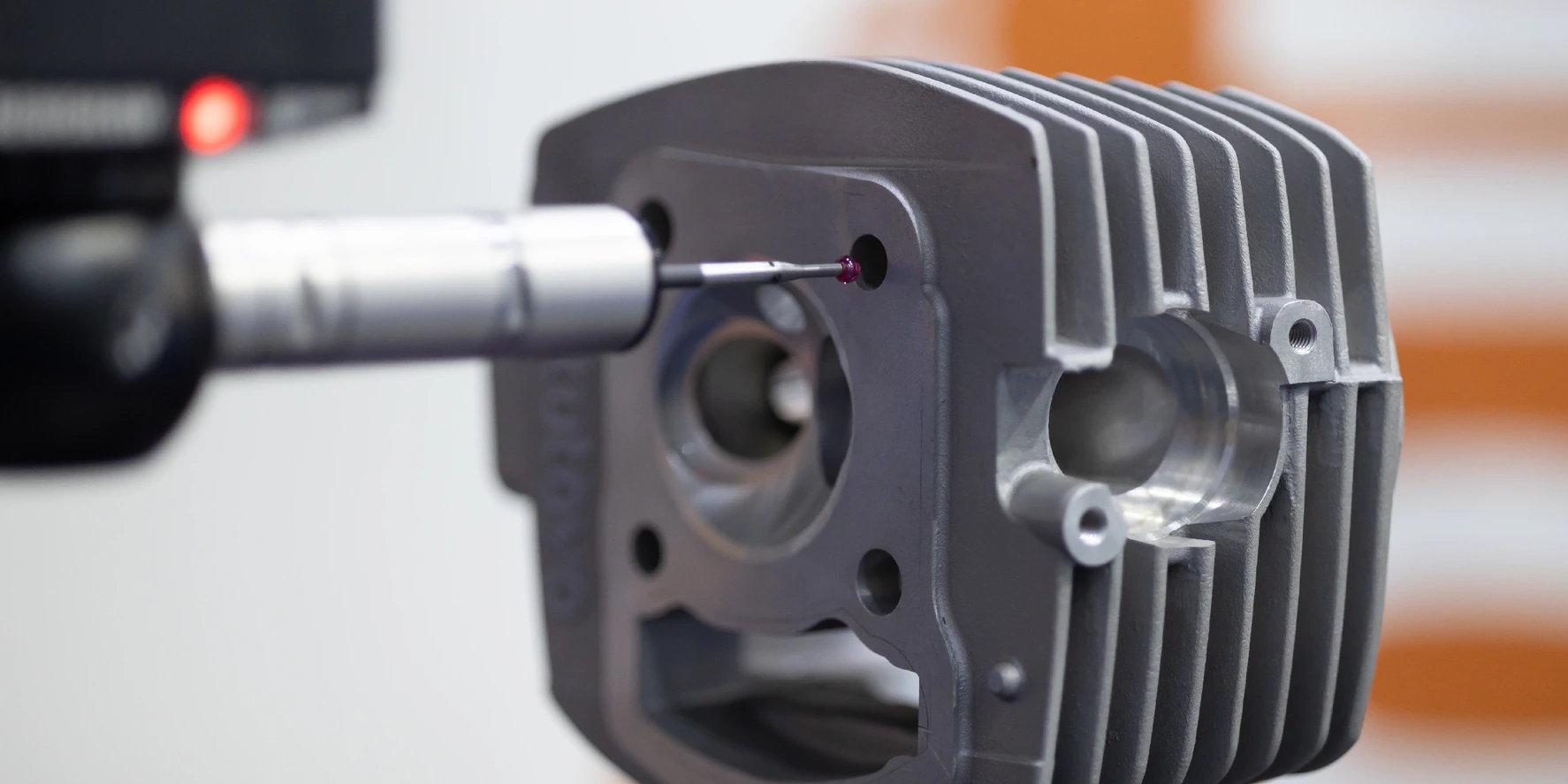 CMM inspection probe measuring a precision CNC machined metal component